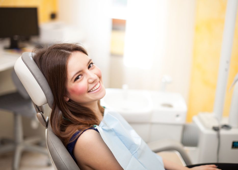 A smiling woman sitting in a dental chair