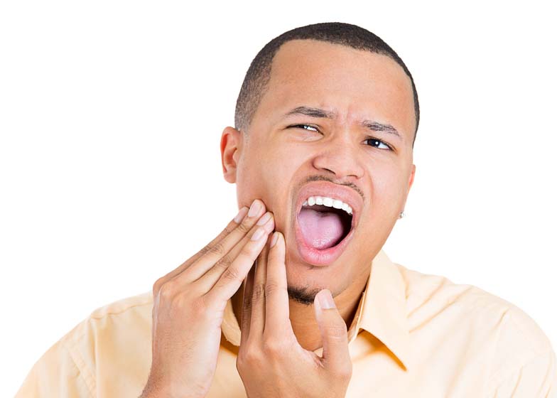 A man experiencing pain in his TMJ